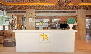 a restaurant with a counter with a logo on it at Treebo Trend The Royal CM in Jaipur