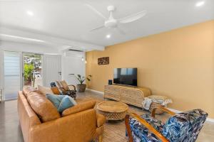 a living room with a couch and a tv at Salty Crab Bungalow in Lennox Head