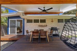 a patio with a ceiling fan and a table and chairs at Salty Crab Bungalow in Lennox Head