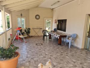 a living room with a table and chairs and a dog at Vida Bhermon 3 , 2 suites in Majdal Shams