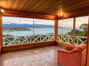 a room with a large window with a view of the ocean at NO PARTY ALLOWED,Sea view 5 bedroom house in Wellington