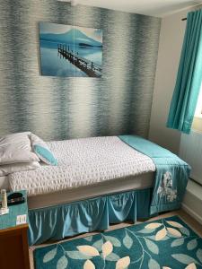 a bedroom with a bed and a picture of a pier at Brewery Farm House Bed & Breakfast in Swindon