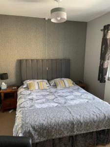a bedroom with a large bed with a blue comforter at Brewery Farm House Bed & Breakfast in Swindon