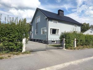 a blue and white house with a fence at Yksityinen kellarikerros omalla sisäänkäynnillä, Pietarsaari in Pietarsaari