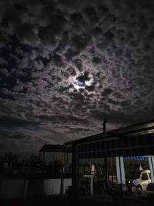 a person standing on top of a building under a cloudy sky at Silo el capricho in Madridejos