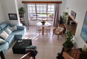a living room with a blue couch and a table at Duplex ORION in Tazacorte