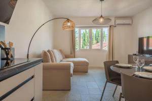 a living room with a couch and a table at 2P neuf au Coeur de St Jean Cap Ferrat in Saint-Jean-Cap-Ferrat