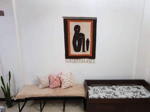 a living room with a bench and a picture on the wall at Mireya's Transient House in Baguio