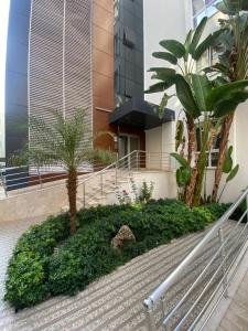 a staircase in front of a building with palm trees at Best Home 17 Kleopatra in Alanya