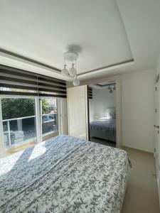 a bedroom with a bed and a large window at Best Home 17 Kleopatra in Alanya