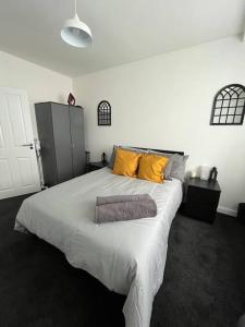 a bedroom with a large bed with two pillows on it at Castle Court Apartment in London