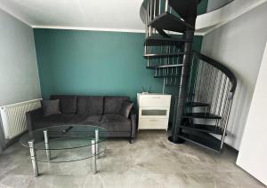 米茲多洛傑的住宿－Marea by Baltic Home，带沙发和螺旋楼梯的客厅