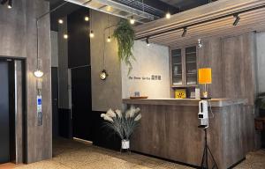 an office lobby with a reception counter and plants at The Retro Tai-Pan in Tainan
