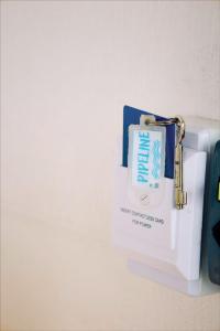 a key chain with a card on a refrigerator at Sea Wolf Surf Hostel in Florianópolis