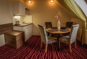 a kitchen and dining room with a table and chairs at Hotel Brixen in Havlickuv Brod