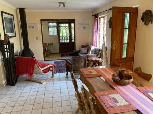 a living room with a wooden table and a couch at Paradise in Kommetjie in Cape Town