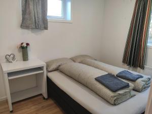 a bed with two pillows on it in a room at FeelHome 2 bedrooms apartment Vidarsveg in Tromsø