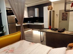 a kitchen with a couch and a table in a room at Sri Kejora Vista Bangi Homestay -Studio in Kajang +32 photos