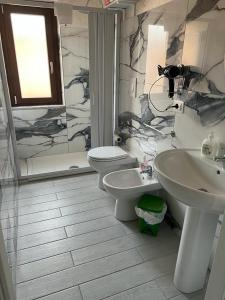 a bathroom with a sink and a toilet and a shower at La Casa Di Chiaretta in Falerna