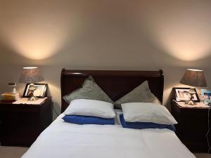 a bed with pillows and two night stands with lamps at Jambase Seaside House in Big Bay +26 photos