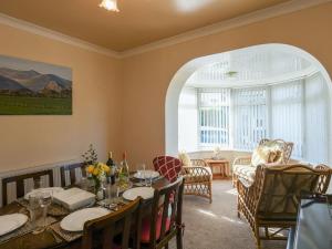 a dining room with a table and some chairs at Maldwyn in Llanegryn