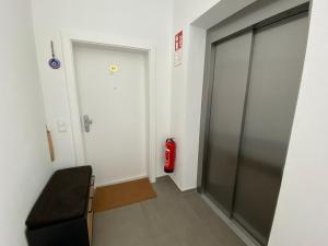 a hallway with a door and a fire extinguisher at Moderne Kaminstube in Ramsau am Dachstein