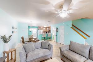 a living room with a couch and a ceiling fan at Woodland Shores #20 in Destin