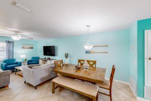 a living room with a table and a couch at Woodland Shores #20 in Destin