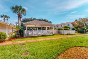 a house with a fence and a gazebo at Woodland Shores #20 in Destin