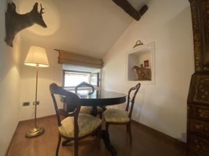 a dining room with a table and two chairs at Ponte del Mera Attic in Chiavenna