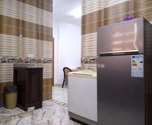 a kitchen with a refrigerator and a counter in a room at Furnished apartment for rent in jarash شقة مفروشة للإيجار في جرش in Jerash