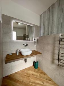 a bathroom with a sink and a mirror at ALBARIA ROOMS-APARTMENTS in Marsala