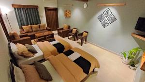 sala de estar con sofás, sofá y mesa en Siolim Suites en Siolim