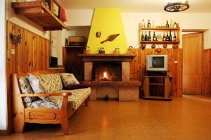 a living room with a couch and a fireplace at Discover Italy in Tignes