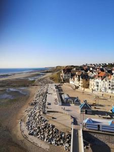 una vista aerea di una spiaggia con rocce e case di La passerelle, duplex atypique de charme a Wimereux