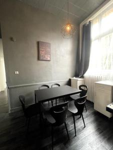 una sala da pranzo con tavolo e sedie di Agréable maison de ville dans la plus belle Avenue a Orléans