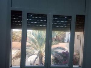 a window with a view of a palm tree at Suite MoonLight zone touristique tozeur in Tozeur