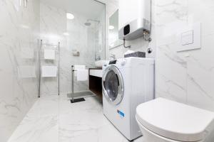 y baño blanco con lavadora. en Sun Residence Krk, en Krk 31 fotos más