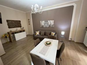 a living room with a table and a couch at ATTICO BRICCARELLO -Intero Appartamento- Elegant Suite with FREE WIFI near PalaAlpitour and Sporting Club Torino-Olimpyc Stadium in Turin