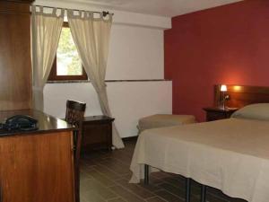 a hotel room with a bed and a window at Il Canalotto in Longi