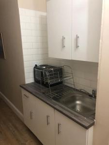 um balcão de cozinha com um lavatório e um micro-ondas em Lovely rental unit with No loadshedding em Sandton