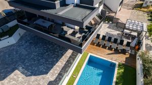 an aerial view of a house with a swimming pool at Villa Porta Salonae in Solin