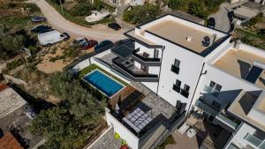 an overhead view of a white house with a swimming pool at Villa Porta Salonae in Solin