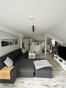 a living room with a couch and a table at Ankerplatz Güby in Güby