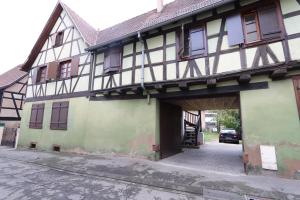 an old building with a garage and a car parked in it at HOMEDAY F2 tous confort très bien placé num4 in Haguenau