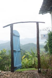 a blue door with a view of the mountains at Pousada Le Monte Cristo in Guaramiranga