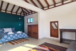 a living room with a bed and a fireplace at Villa RenaSer in Villa de Leyva
