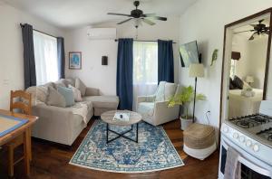 uma sala de estar com um sofá e uma mesa em Hummingbirds Cabins em Caye Caulker