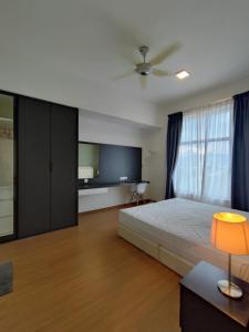 a bedroom with a large bed and a tv at Mint Cabin @ Oasis Condo Ipoh in Ipoh