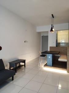 a living room with a table and a couch at Mint Cabin @ Oasis Condo Ipoh in Ipoh